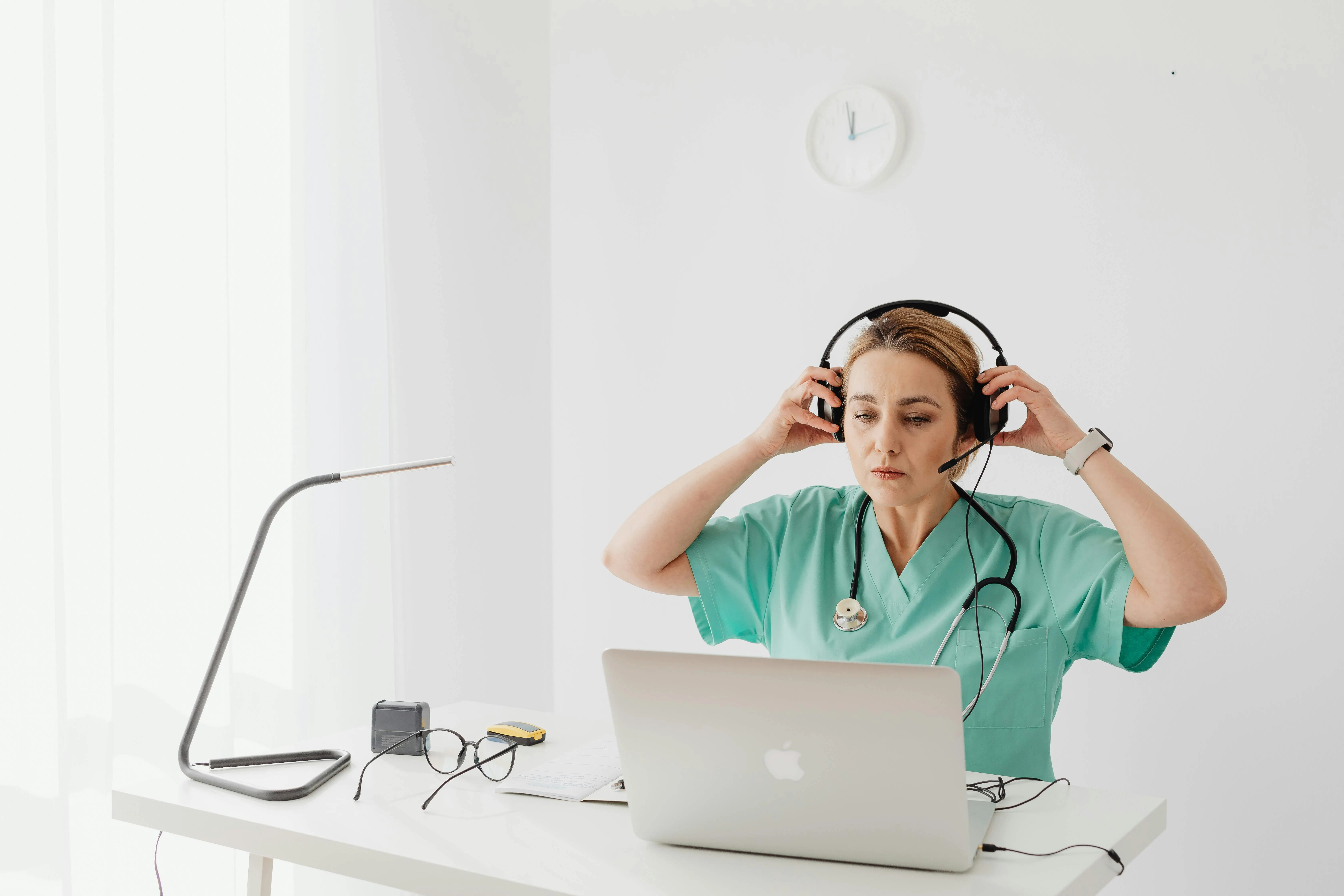Caregiver assisting an elderly resident with technology